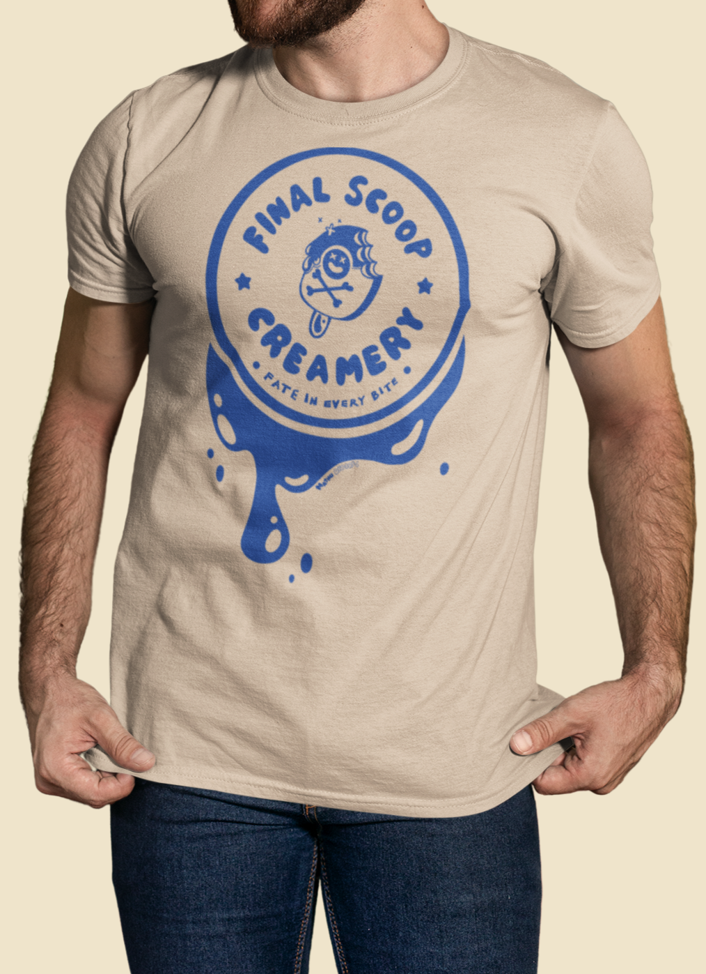 Man wearing a beige t-shirt with a blue logo on a beige background