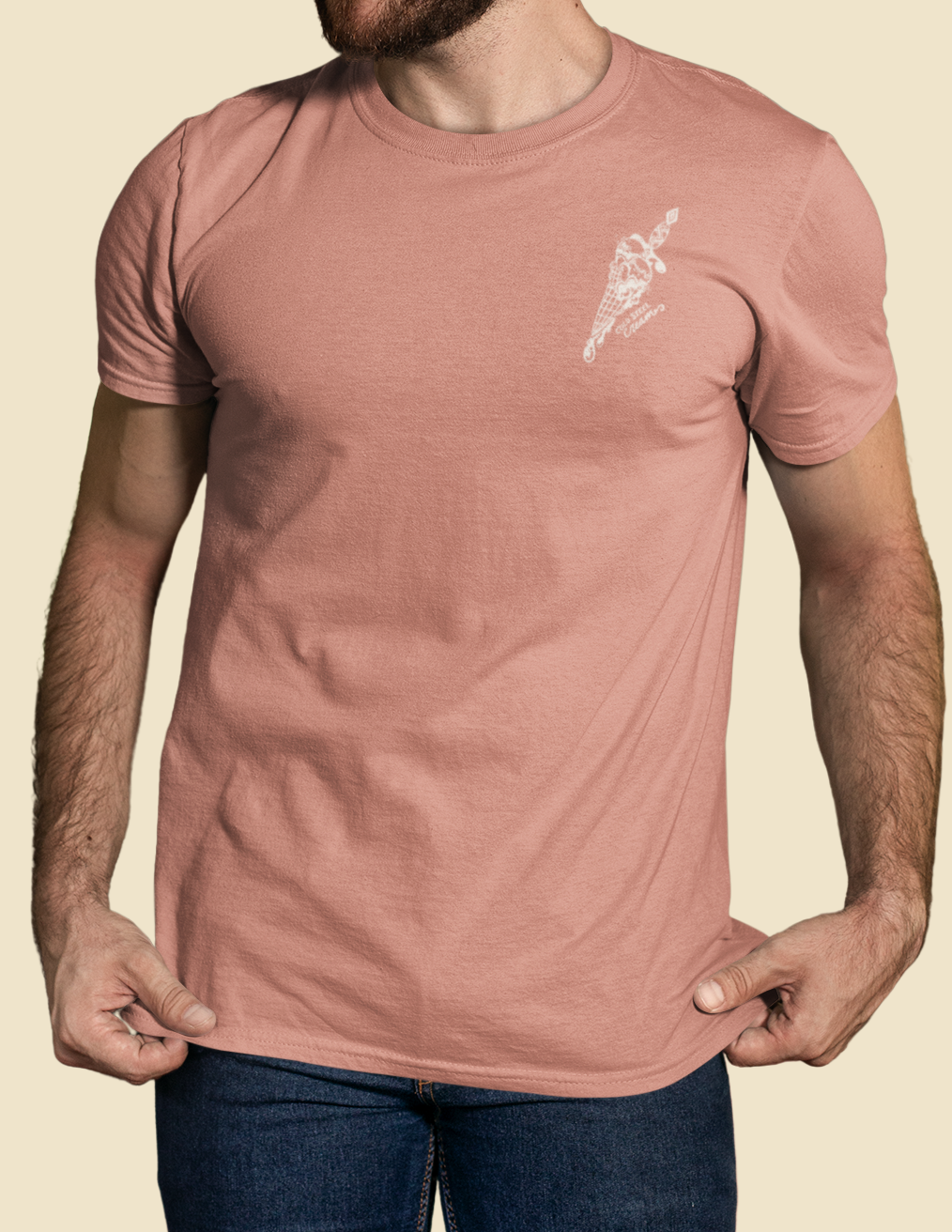 Man wearing a pink t-shirt with a small graphic on a beige background