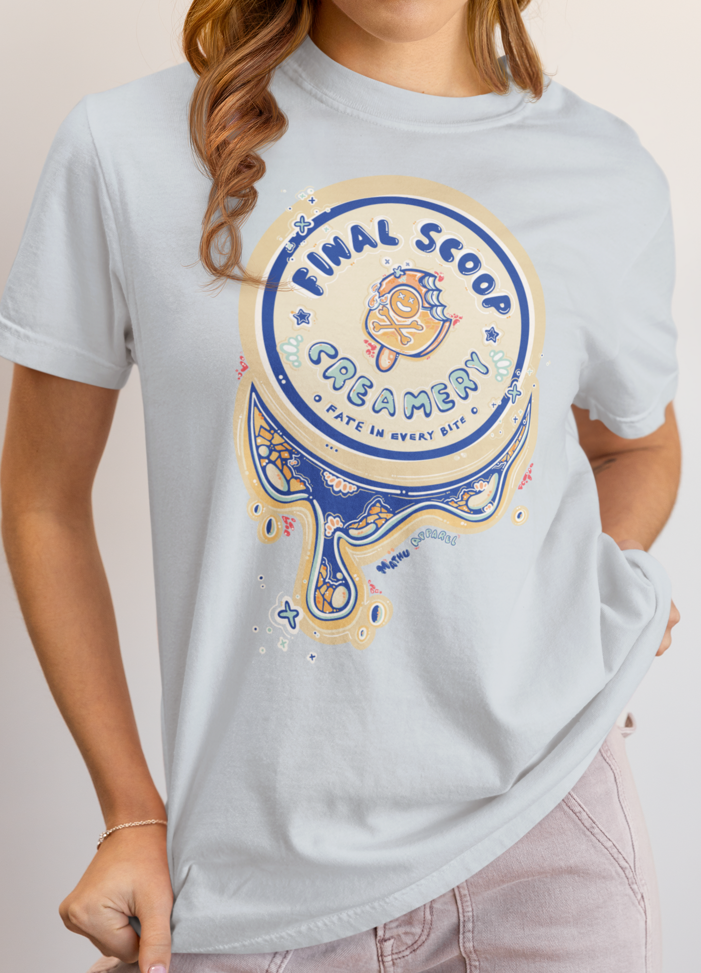 Person wearing a light blue t-shirt with a 'Final Scoop Creamery' graphic design.